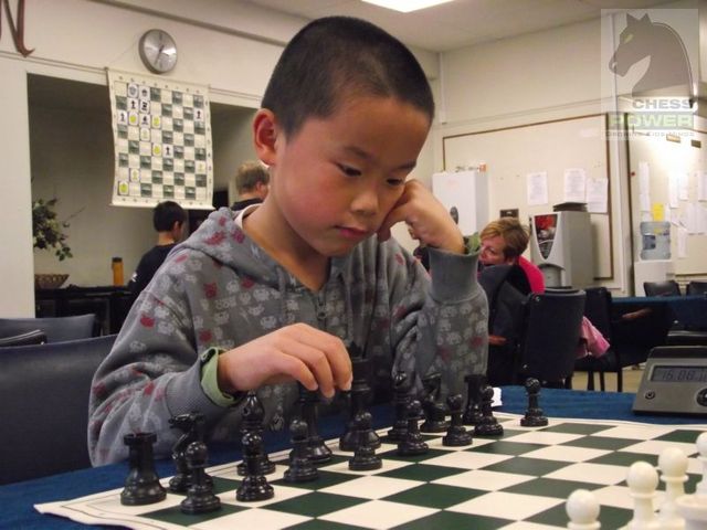 Tony Tang prepares his first move with the Black pieces