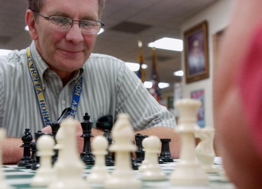 Chess Coach helping a student