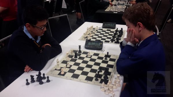 Aaron Guo [left] (Hebron Christian College) executes a power fork on Harrison Coates' [right] (St Kentigern Primary) queen and rook